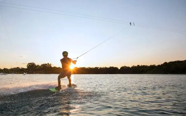 A person wake boarding sunset 