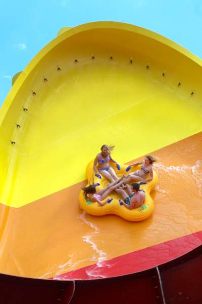 Four people on the Tornado Wave water slide
