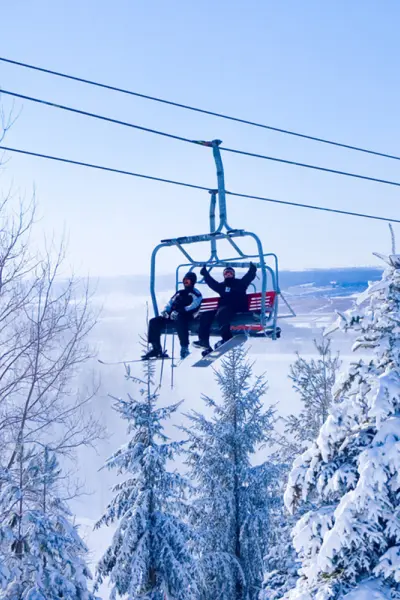 People riding ski lift