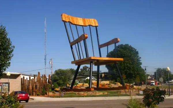 A gigantic sized rocking chair in casey against a blue sky