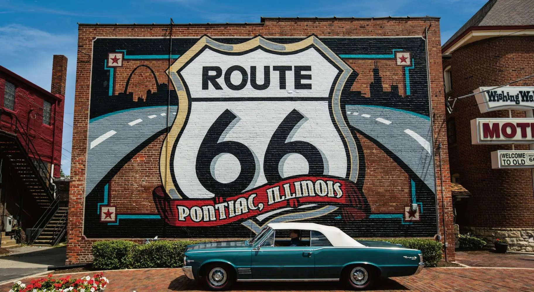 Route 66 Mural with a Pontiac car in front.