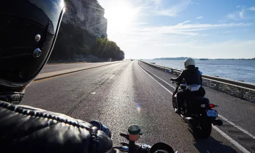 Motor bikers riding by the river
