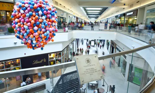 A view of stores and shoppers from an upper level of Fashion Outlets of Chicago