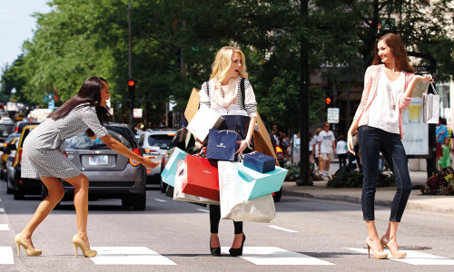 Women walking across the street with shopping bags