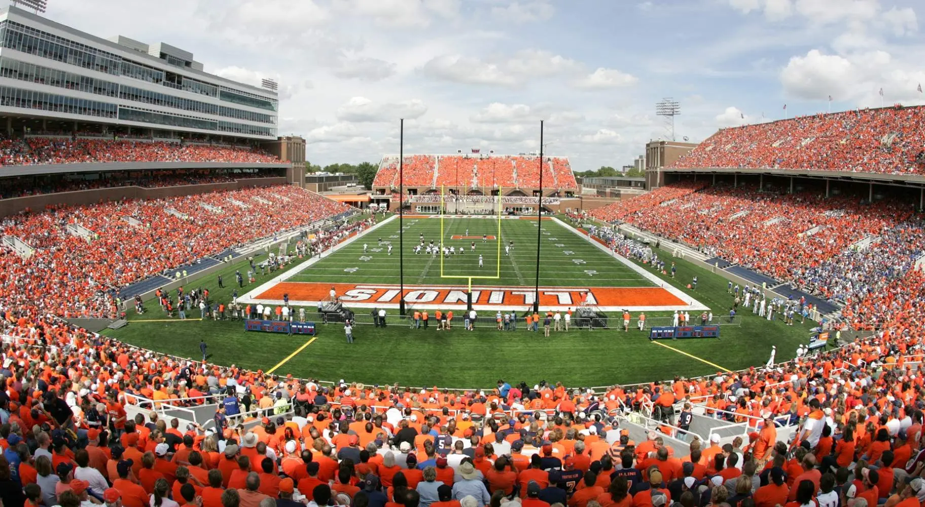 A crowded football stadium on game day, with many spectators dressed in orange