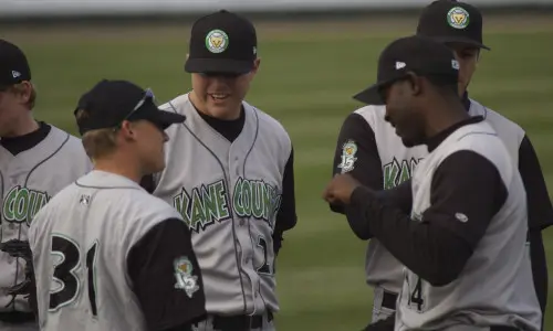 Players talk strategy at a Kane County Cougars game