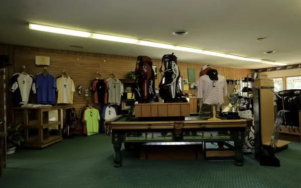 A golf pro shop with golf attire and clubs for sale