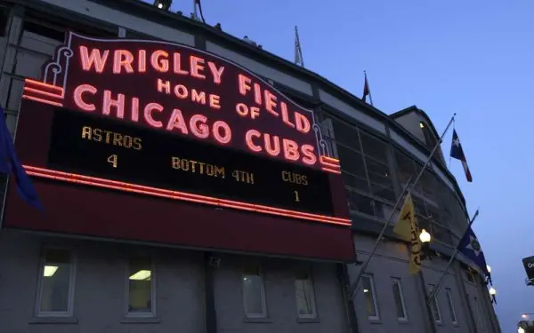 Wrigley Field sign lit up in the evening