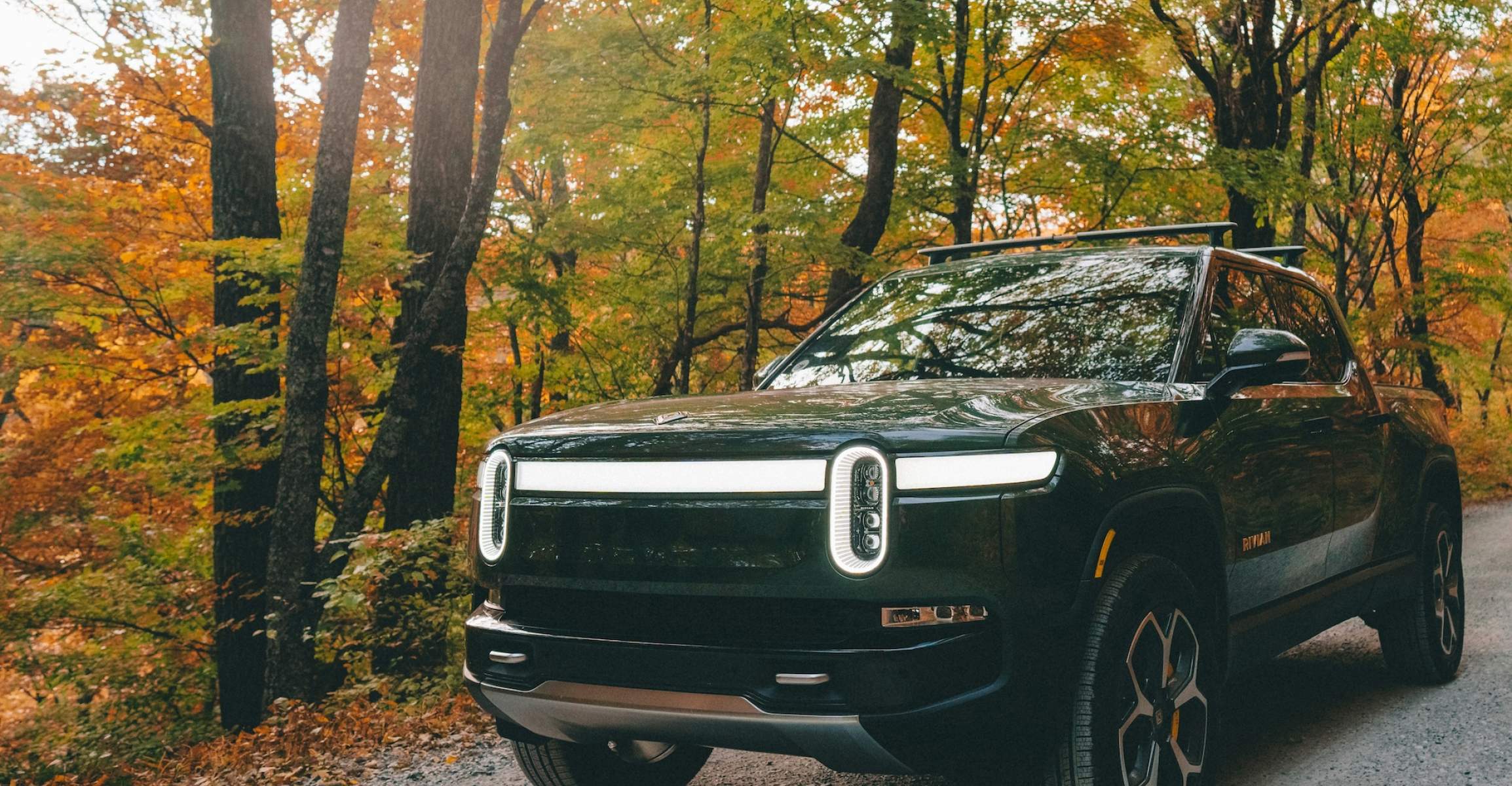 Rivian Electric Vehicle Driving on a Gravel Road