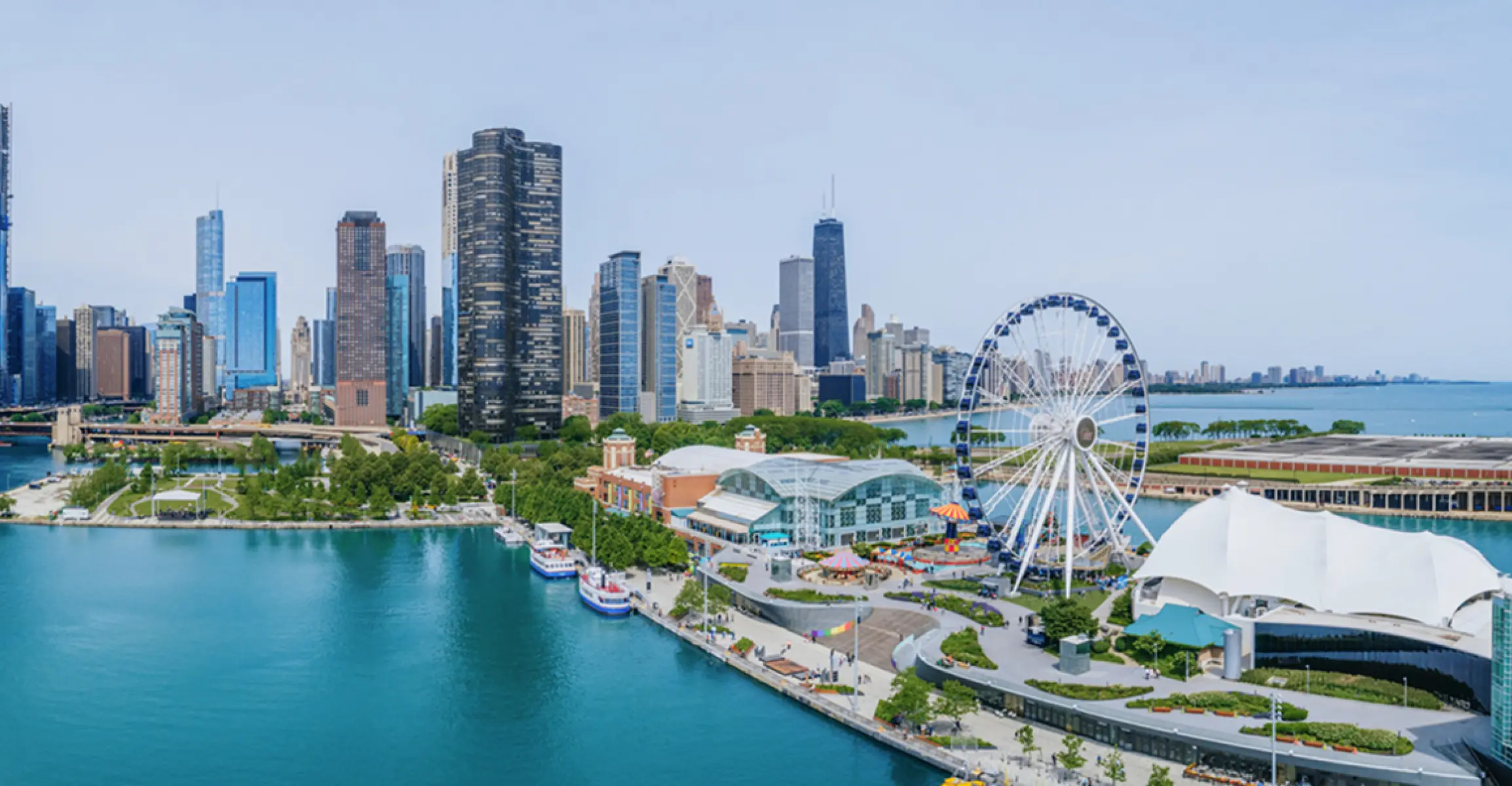 Aerial view of Navy Pier and the Chicago skyline along Lake Michigan on a clear day.