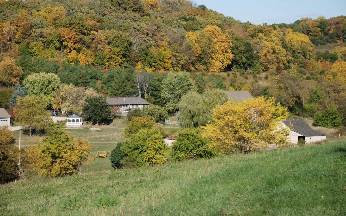 Landscape style view of cottages, gazebo and trees
