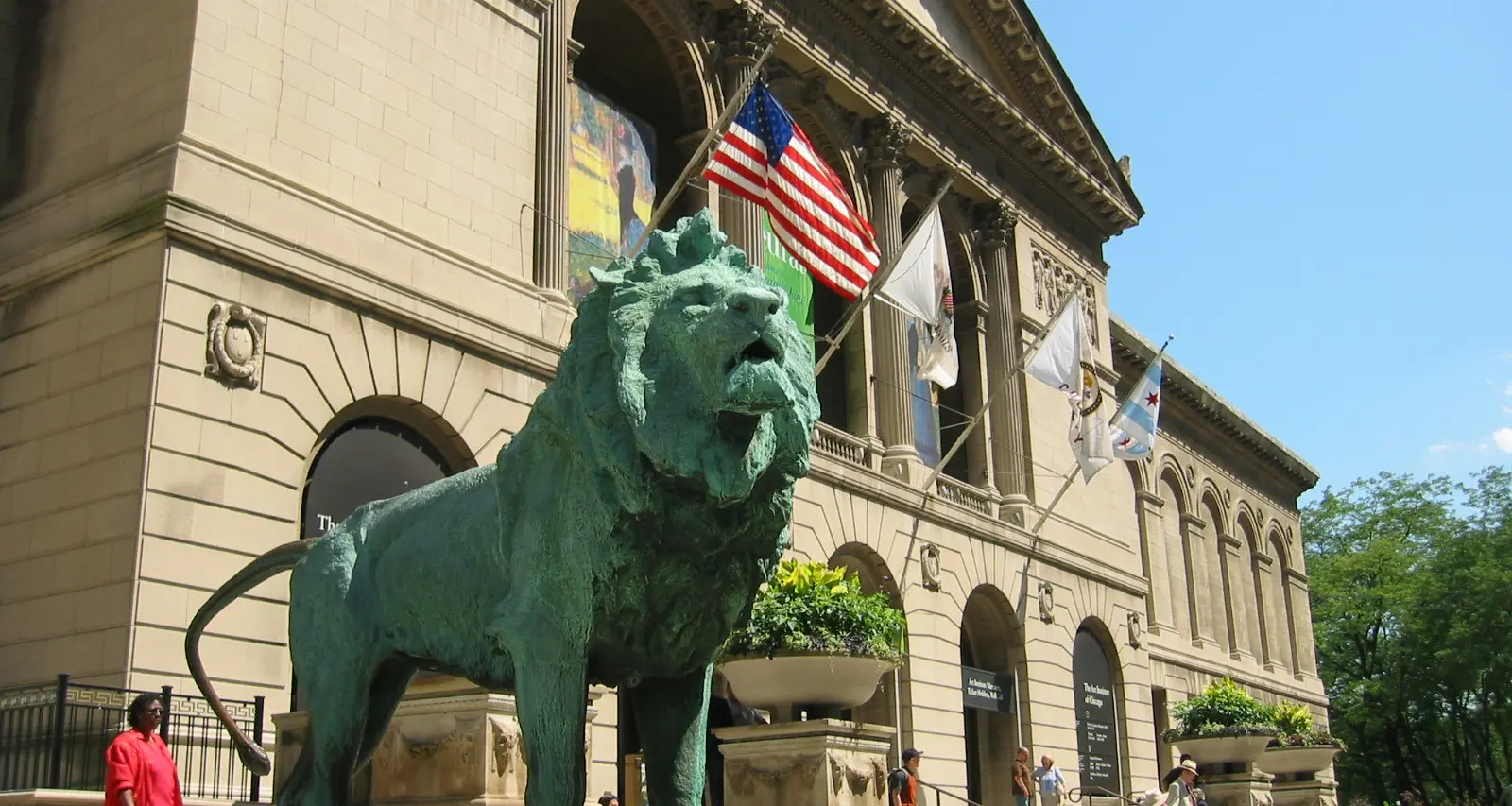 A lion statue outside a big museum