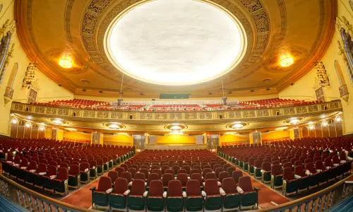 An ornate two-level theatre auditorium, as seen from the stage