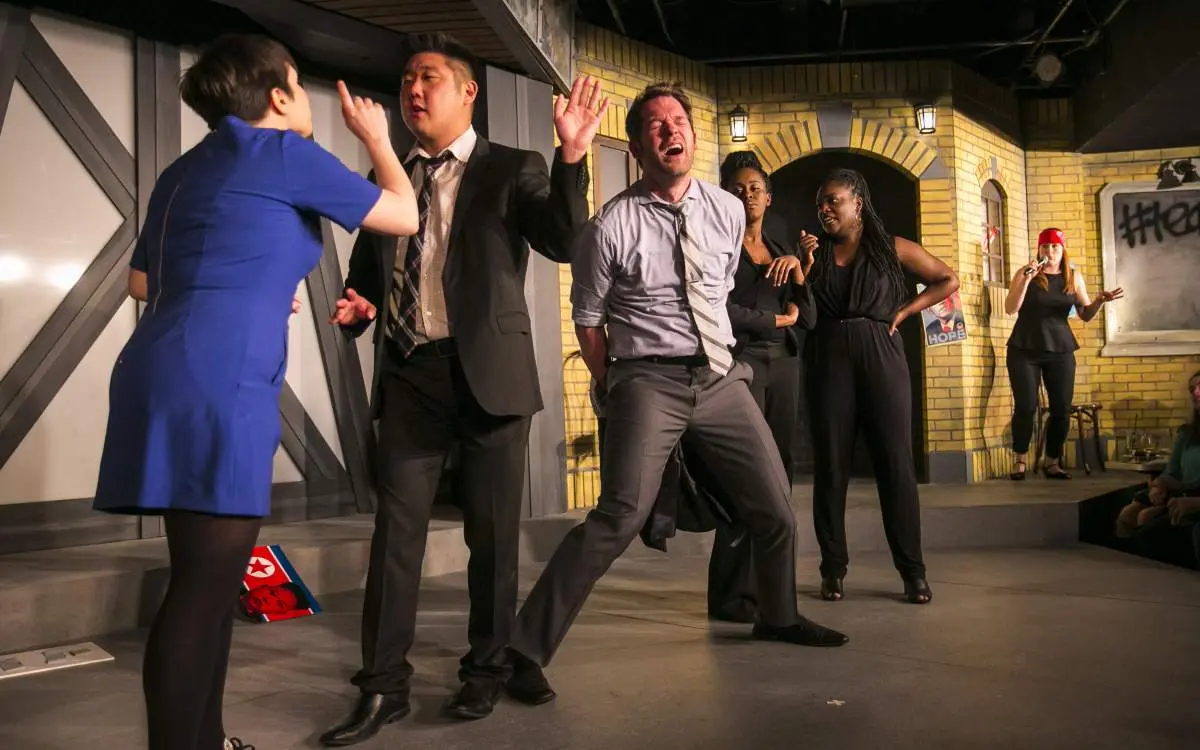Actors acting on stage at the Chicago Theatre.