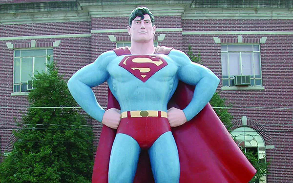 a statue of Superman outside a building