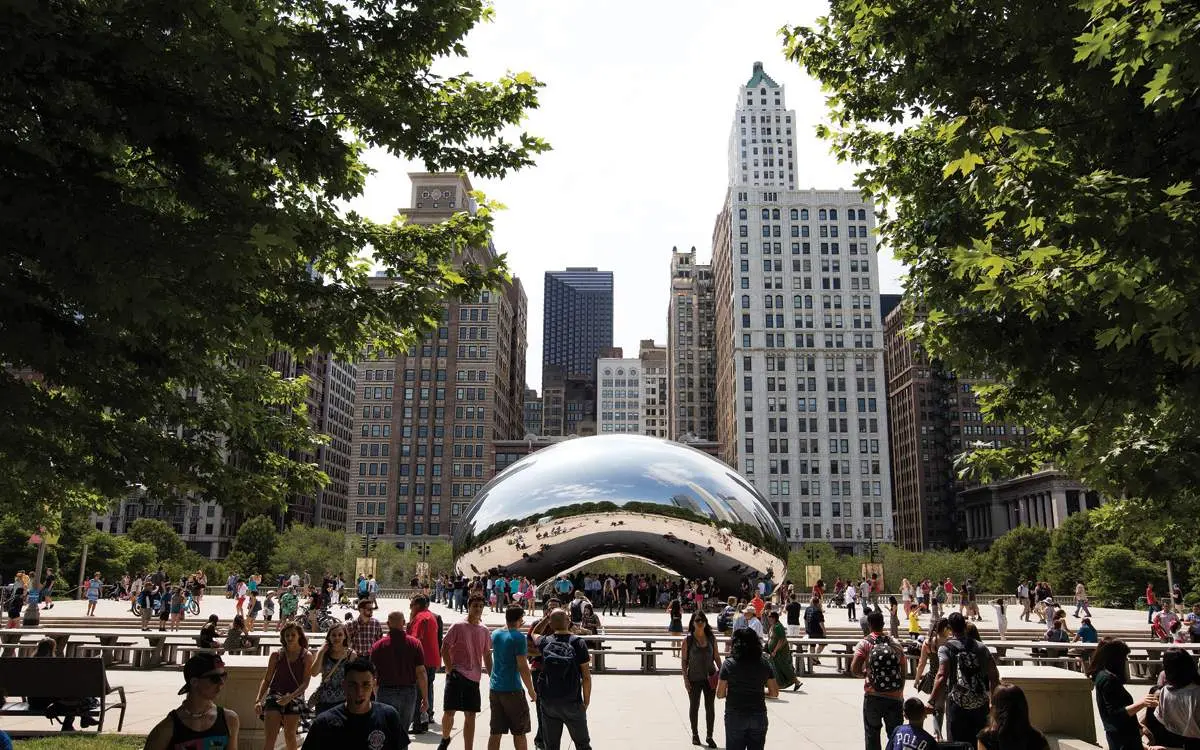 Tourists surrounding the bean sculpture in Chicago