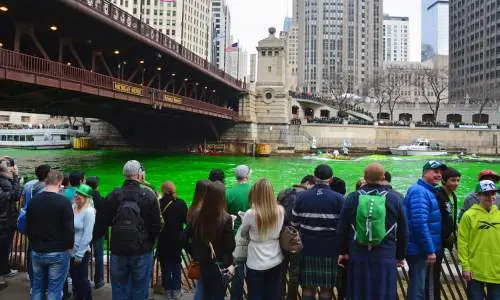 Crowd watching the river get dyed