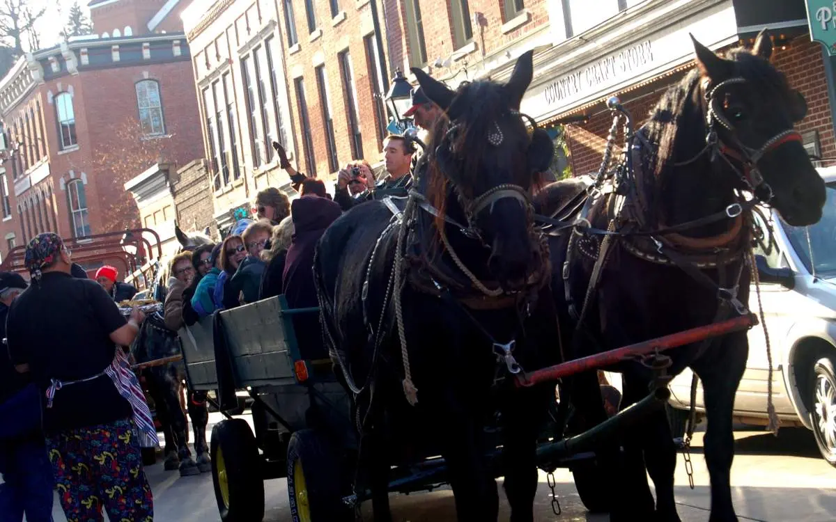 A horse cart carrying people down a street