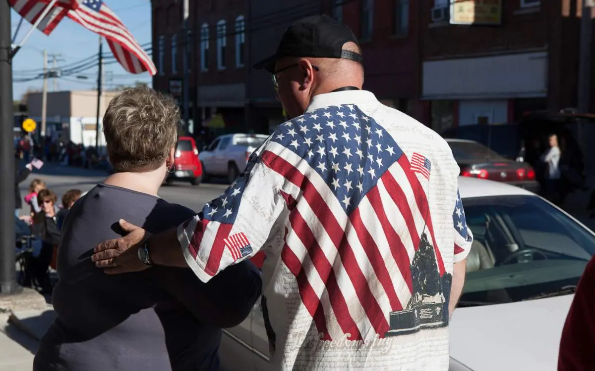 A man in an American flag shirt standing with a woman in the Goreville main street