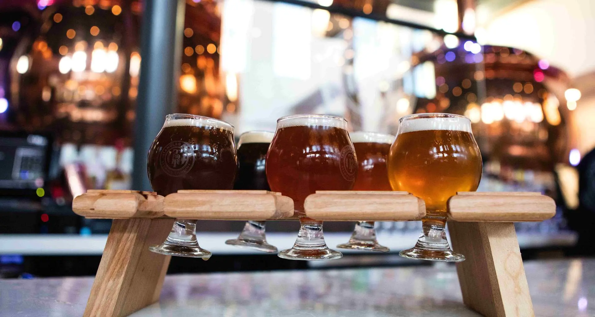 five craft beers sitting in a stand