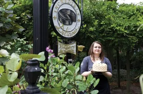 A lady holding a cake