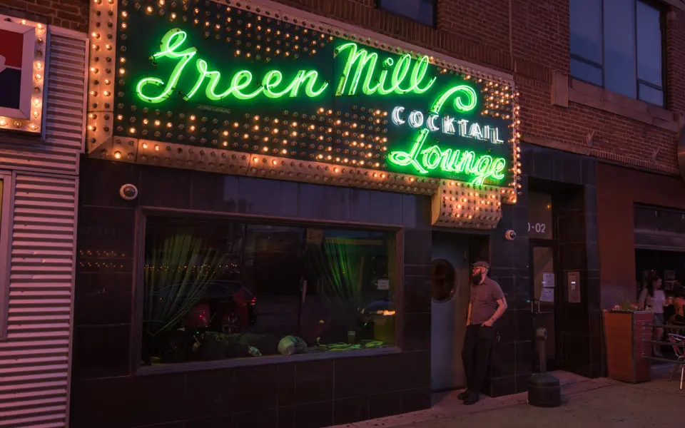A lit up sign on the side of a building