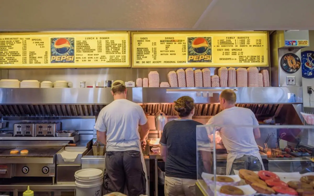 Three people cooking in a fast food place