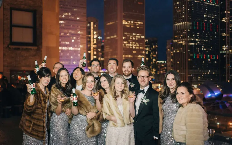 A group of friends celebrating and drinking at Cindy's rooftop bar