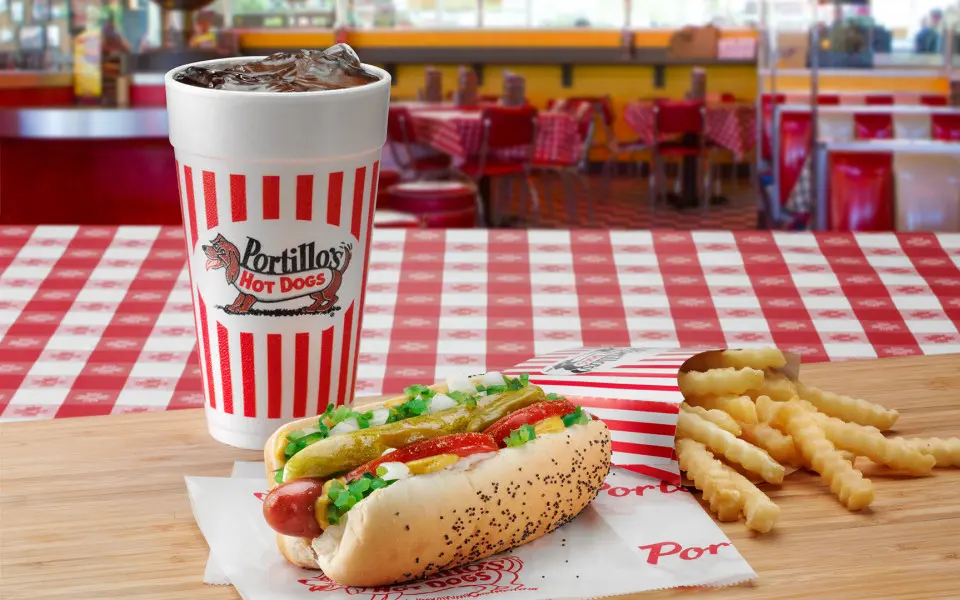 Coke, a hot dog and chips on a table