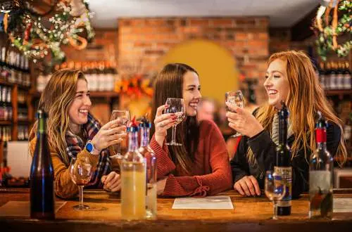 Three woman drinking wine together