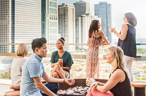 People conversing and eating