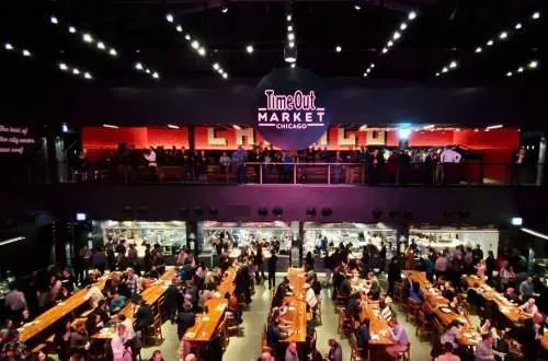Multiple long tables and chairs at the Time Out Market.