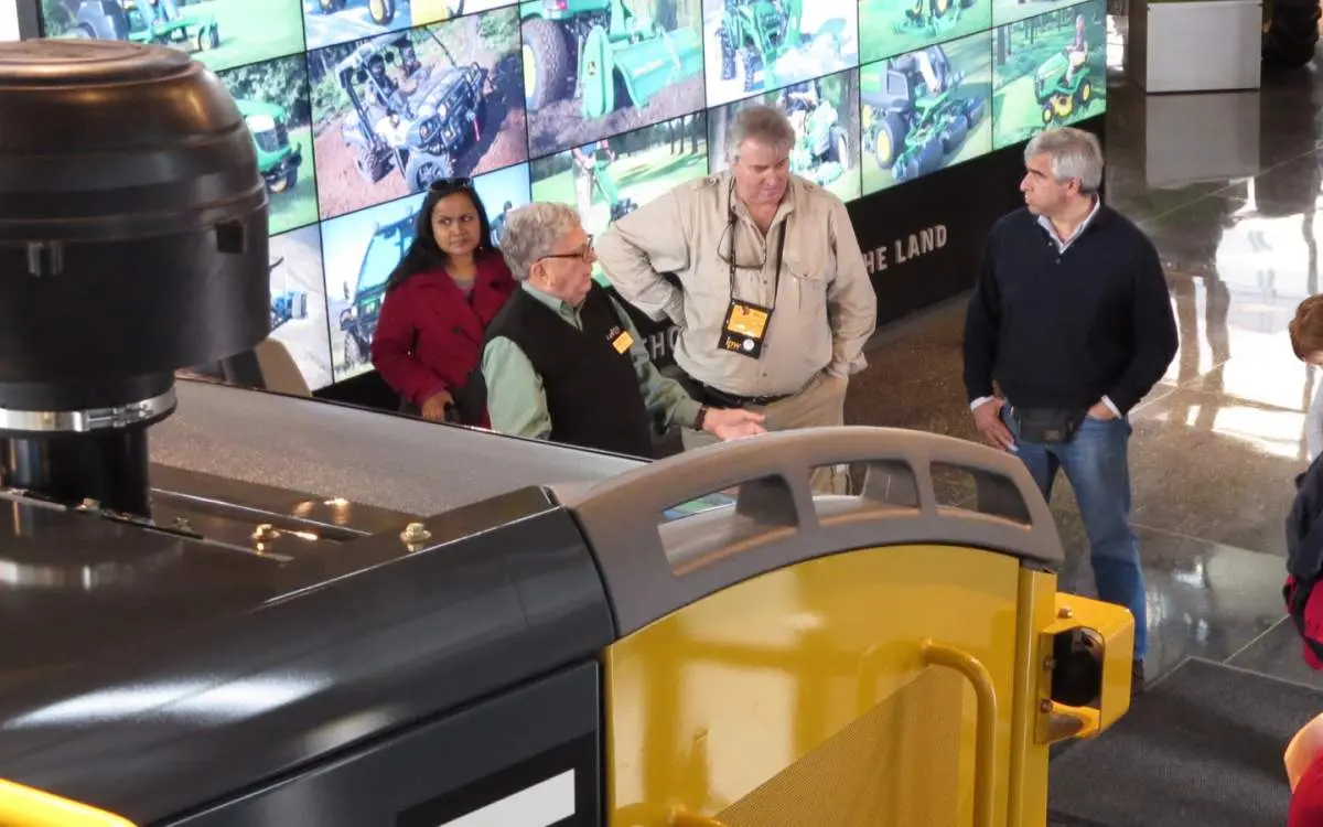 People standing around listening to a man talking