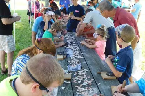 Kids and Adults Flint Knapping at the Mounds State Historic Site