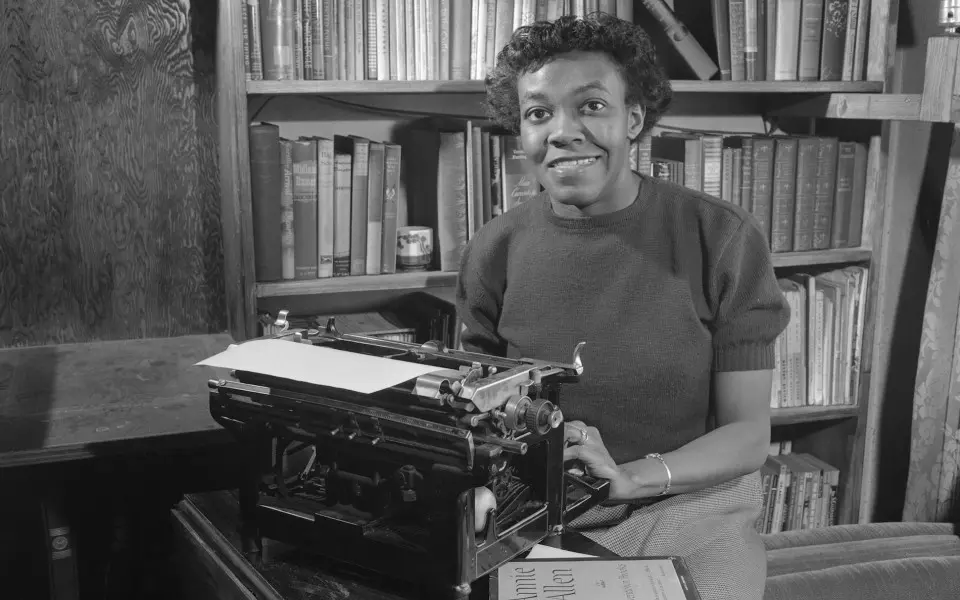 Woman sitting at type writer in library