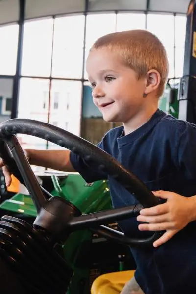 A kid sitting on a tracker