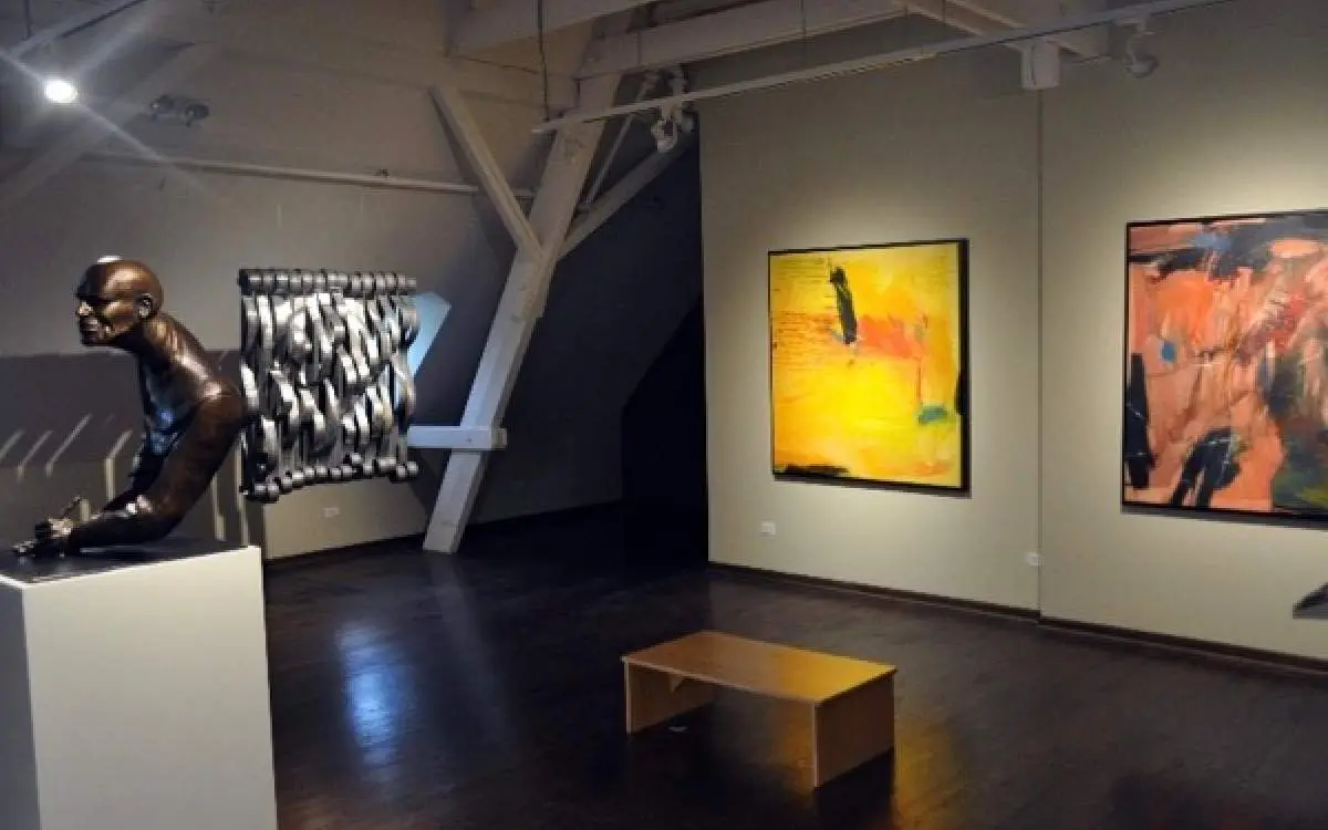 The interior of a museum with art on the walls