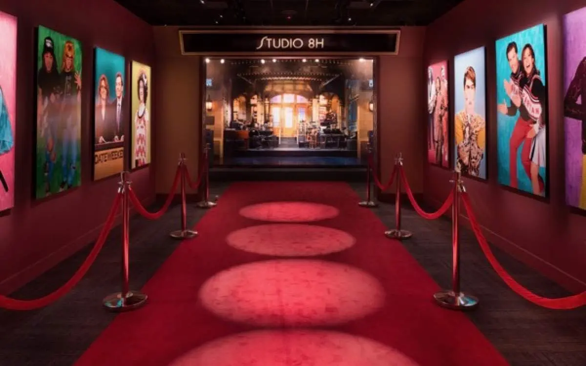 A red carpet with pictures on the side of the wall