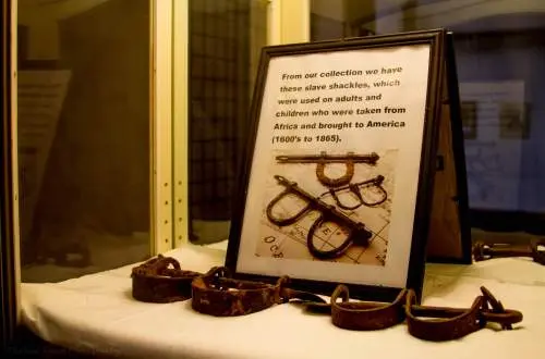 Rusty shackles on a table with a picture and explanation