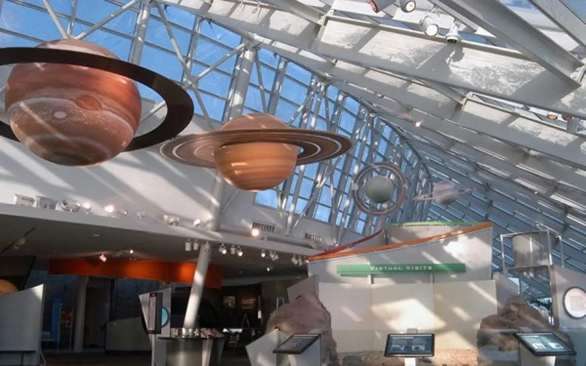 Inside a building with planets hanging from the roof