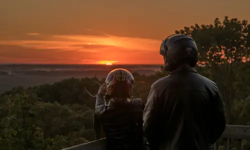 Two bikers with view of Pere Marquette State Park at sunset