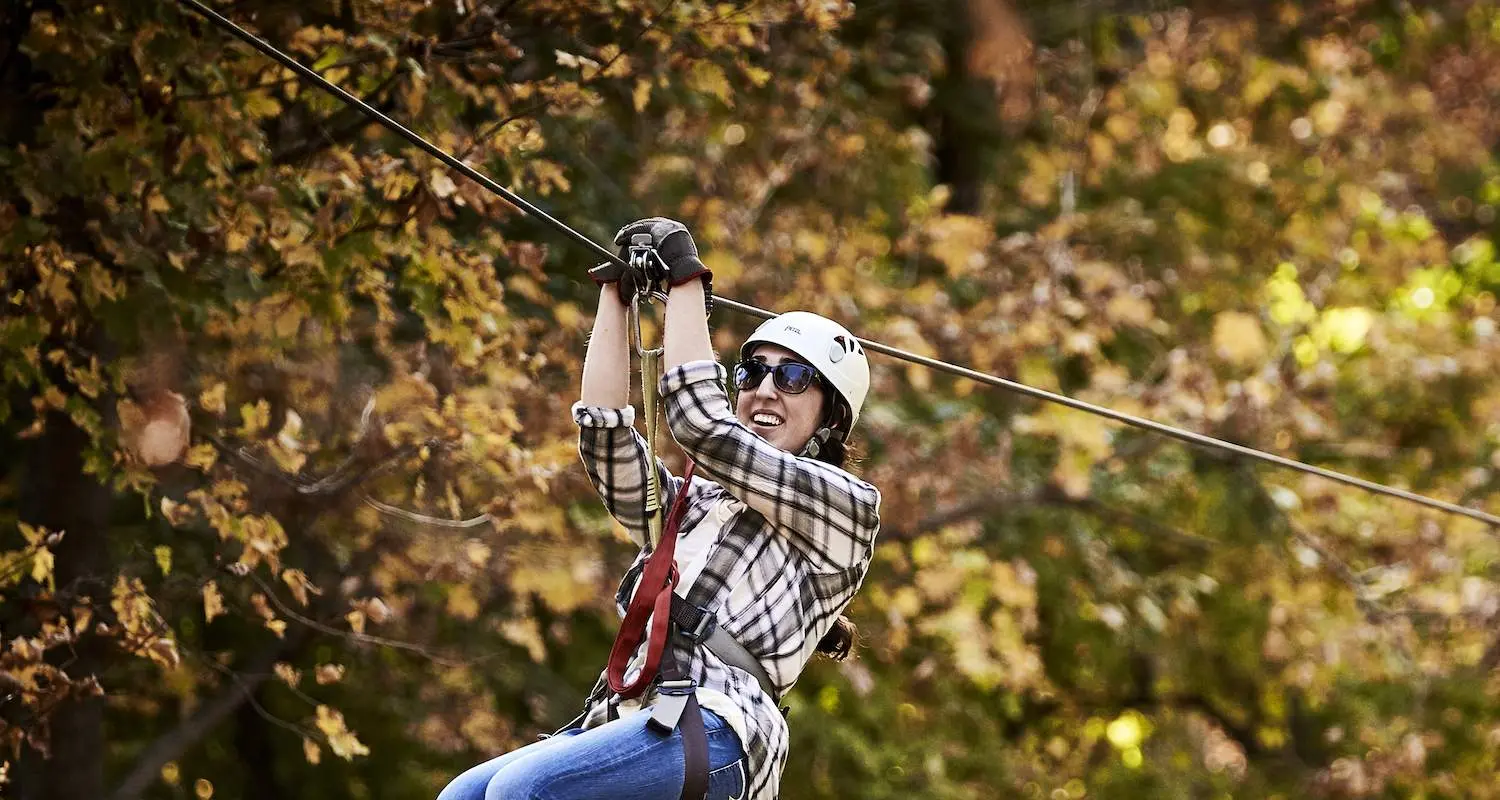 A woman rides a zipline