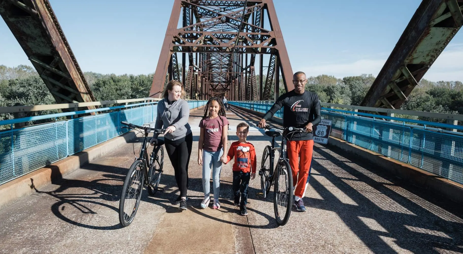 Family with bikes on a bridge