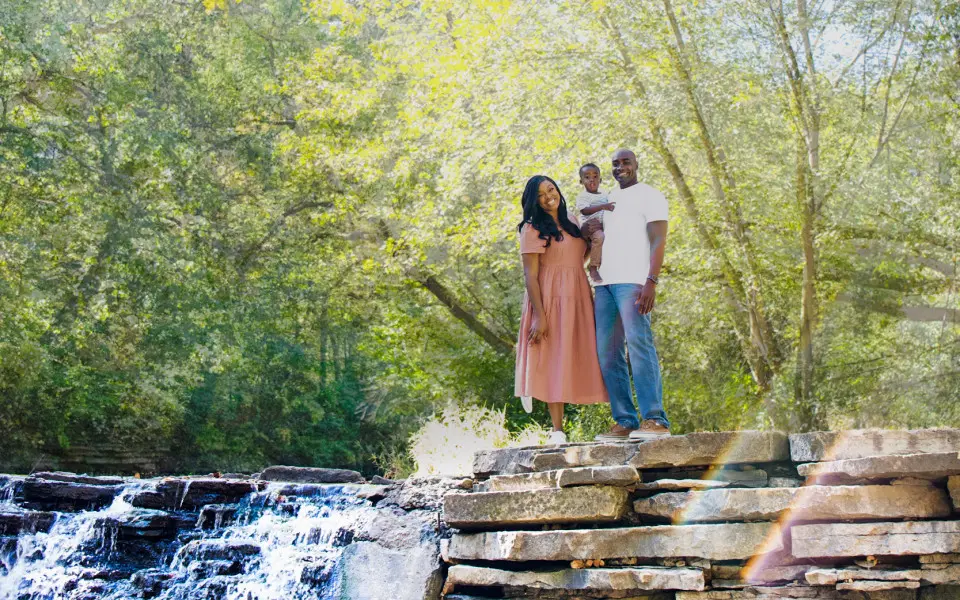 Family standing near top of waterfall at Waterfall Glen Forest Preserve