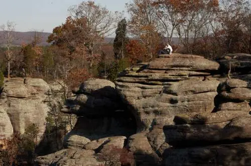 Big rocks with a person sitting on one