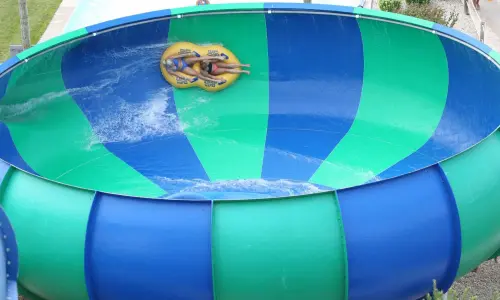 Mother and daughter on inflatable tube on a water slide