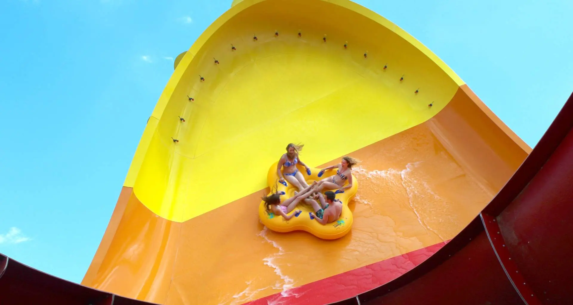 Four people on the Tornado Wave water slide