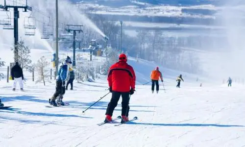 Skiiers skiing down chestnut mountain