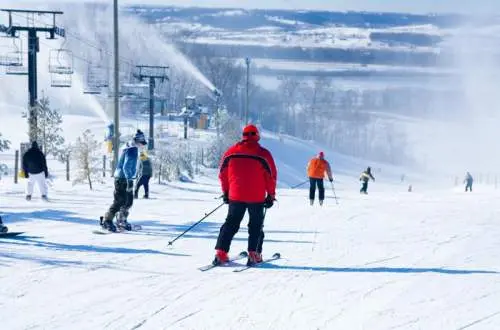 Skiiers skiing down chestnut mountain