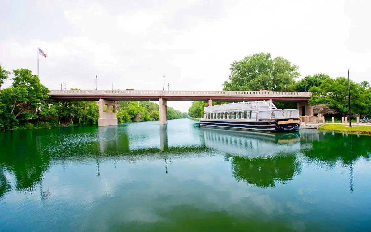 Boat on water with a bridge in the background